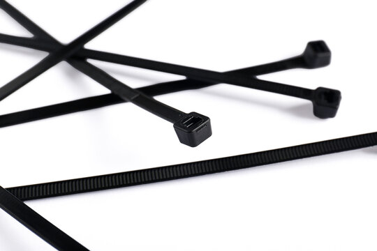 Black cable ties on a white background shot close-up