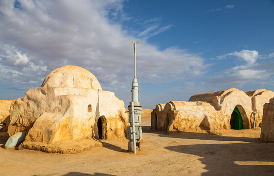 View of the Mos Espa film set featuring iconic dome-shaped structures and desert architecture under a clear blue sky in Nefta, Tozeur Governorate, Tunisia.