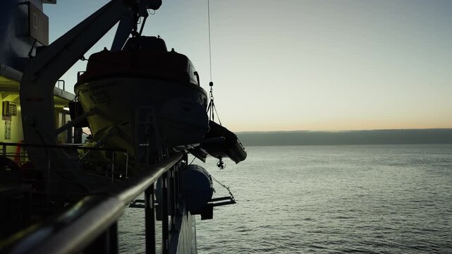 A crew lifts a zodiac onto the ship from the waters of The Gal&aacute;pagos Islands (4K).