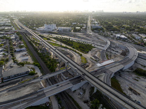Aerial view of the Golden Glades Interchange with multi-level highway ramps, construction zones, and traffic flowing through the urban landscape of Miami, Florida, United States.