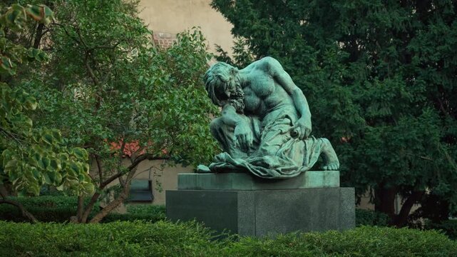 Bronze statue of Orpheus in a Prague park represents deep grief, sorrow, and philosophical thought. This historic Czech monument symbolizes loss, despair, and artistic sculpture.