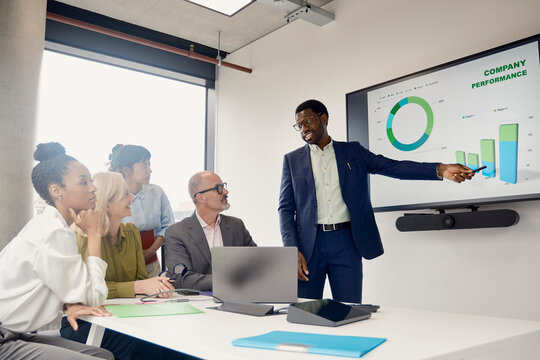 Businessman presents strategy to colleagues in office