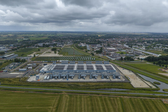 Aerial view of the Google data center facility surrounded by solar panels, green fields, and a canal in Winschoten, Netherlands.