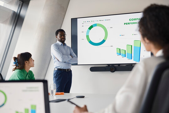Man gives a business presentation to colleagues in a London office