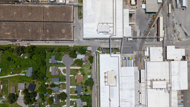 Aerial view of the Tropicana industrial facility featuring large white rooftops and processing buildings adjacent to a residential neighborhood in Bradenton, Florida, United States.
