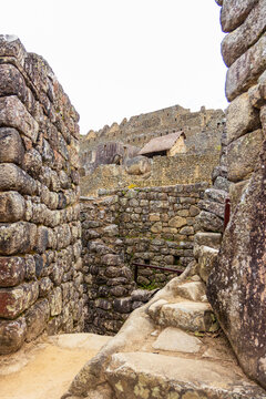 View of the ancient stone walls and historic structures of the Machu Picchu archaeological site in Cusco, Cusco, Peru.
