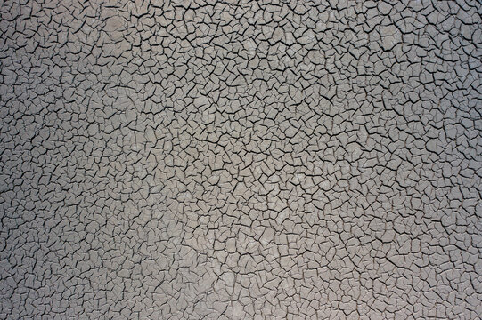 Aerial view of the intricate cracked mud pattern at Lumpur Lapindo, showcasing the dry, textured surface of the mud volcano site in Kecamatan Porong, Jawa Timur, Indonesia.