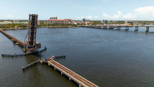 Aerial view of the historic railroad drawbridge in the open position over the Manatee River with the downtown Bradenton skyline in the background, Bradenton, Florida, United States.