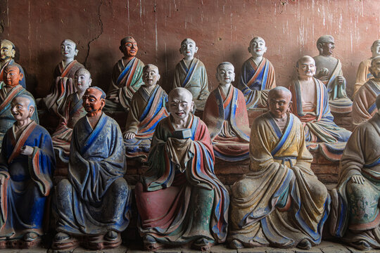 View of the colorful painted clay statues of Buddhist monks and arhats inside the historic Foguang Temple in Xinzhou, China.