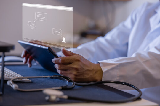 Doctor using digital interface and stylus for online medical communication in a modern clinic healthcare technology