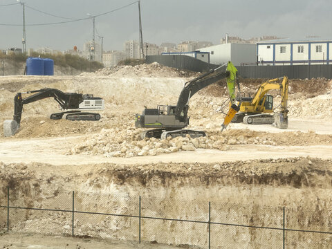 View of construction site with multiple excavators working on rocky ground in Basaksehir, Istanbul, Turkiye.