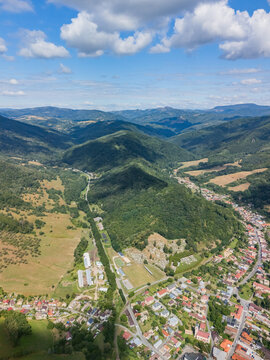 Aerial view of the town nestled in the rolling green hills and forests of Kokava nad Rimavicou, Banska Bystrica Regio, Slovakia.