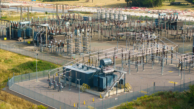 Aerial view of Berkswell Substation featuring high-voltage electrical equipment, transformers, and metal infrastructure within a fenced compound in Coventry, England, United Kingdom.