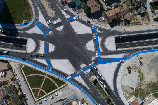 Aerial view of Beysehir Caddesi intersection featuring blue painted bicycle lanes, asphalt roads, and urban surroundings in Konya, Konya, Turkiye.