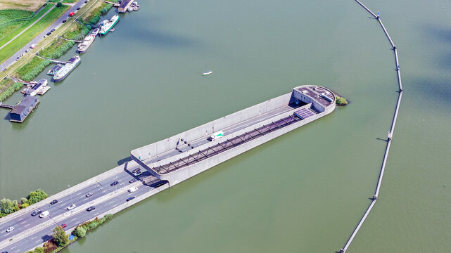 Aerial view of the Zeeburgertunnel entrance with traffic flowing on the highway, situated in the water of the IJ, Amsterdam, Noord-Holland, Netherlands.