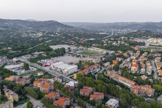 Aerial view of Stadio Partenio-Adriano Lombardi surrounded by residential buildings, lush green trees, and urban infrastructure in Avellino, Campania, Italy.