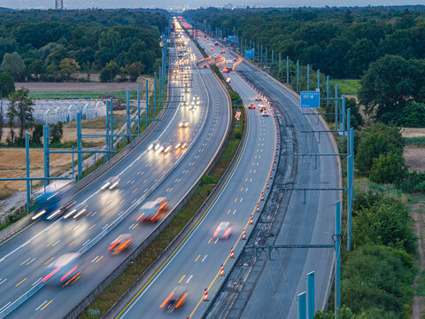 Aerial view of the Teststrecke Oberleitung fur LKW eHighway with overhead power lines for electric trucks, featuring traffic with motion blur in Weiterstadt, Hessen, Germany.