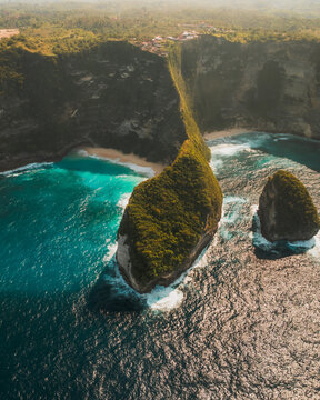 View of the dramatic limestone cliffs and turquoise waters of Kelingking Beach in Nusa Penida, Bali, Indonesia.