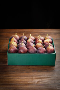 Fresh Red Purple Figs in Green Box on Wooden Table - Organic Fruit Produce