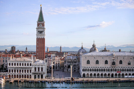Aerial view of St. Mark's Campanile and the Doge's Palace overlooking the historic waterfront and lagoon in Venice, Veneto, Italy.