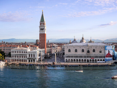 Aerial view of St. Mark's Square featuring the Doge's Palace and St. Mark's Campanile, with gondolas moored along the waterfront in Venice, Veneto, Italy.