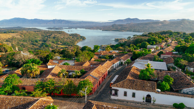 Aerial view of the colonial town of Suchitoto with red-tiled roofs, narrow streets, and lush greenery, overlooking the Suchitlan Lake in Suchitoto, Cuscatlan Department, El Salvador.