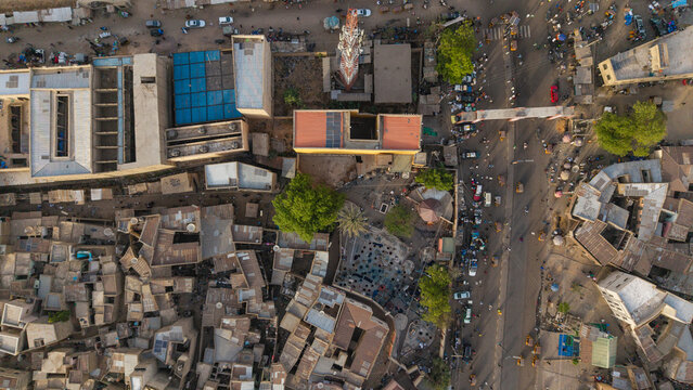 Aerial view of the historic city of Kano, featuring dense urban architecture, flat-roofed buildings, a prominent communication tower, and busy streets, Kano, Kano, Nigeria.