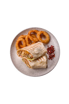 Grilled chicken shawarma or doner with tomatoes, cucumber, and sauces, takeout food