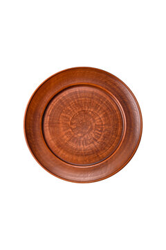 An empty round ceramic plate on a dark, textured brown background. An empty round plate