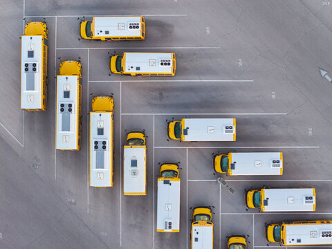 Aerial view of yellow school buses parked in an organized lot with marked spaces in Las Vegas, Nevada, United States.