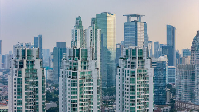 Aerial view of modern skyscrapers and high-rise residential towers in the city center of Jakarta, Indonesia.