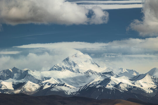 View of Mount Everest with snow-capped peaks and dramatic clouds in the Himalayas, Tibet, China.