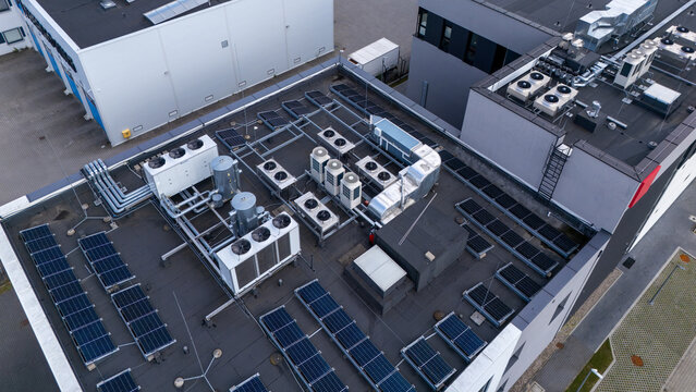 Aerial view of Data Center Rooftop with HVAC Cooling Units and Solar Panels for Cloud Computing and Sustainability