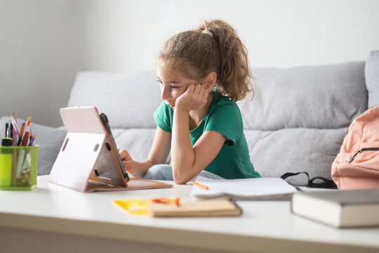 Girl studying with tablet at home