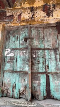 Textured design or architecture of old doors in closed houses in Chandni Chowk, New Delhi.