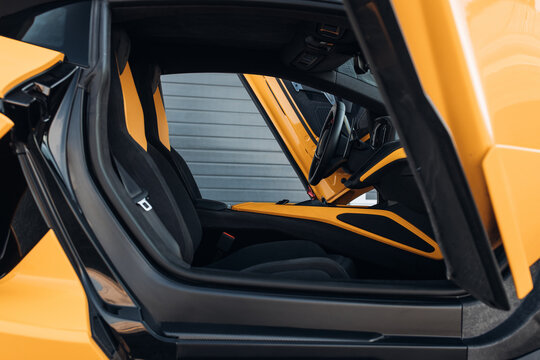 Modern supercar interior with leather panel, sport seats, multimedia and digital dashboard