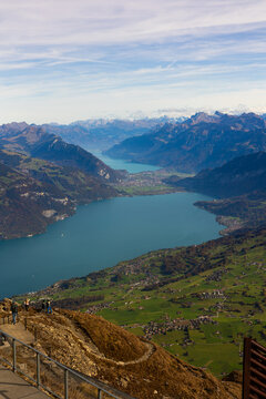 Aerial view of Niesen Hiking View Point overlooking Lake Thun and the lush green slopes of the Bernese Oberland in Reichenbach im Kandertal, Canton of Bern, Switzerland.