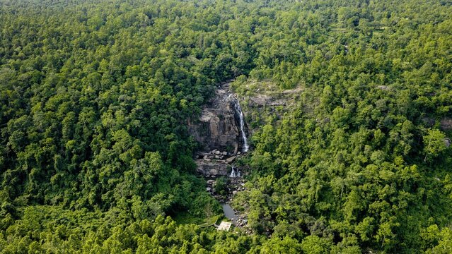 Aerial view of Sita water falls cascading through dense green forest vegetation in Singhdih, Jharkhand, India.