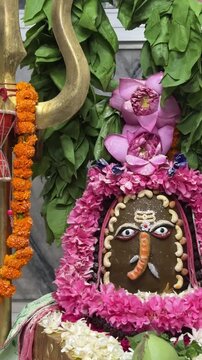 4k clip of Shivling or shiv lingam decorated with colours and flowers to worship lord shiv. Selective focus.