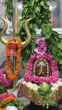 4k clip of Shivling or shiv lingam decorated with colours and flowers to worship lord shiv. Selective focus.