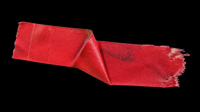 Worn red adhesive tape strip isolated on black background