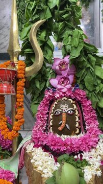 4k clip of Shivling or shiv lingam decorated with colours and flowers to worship lord shiv. Selective focus.