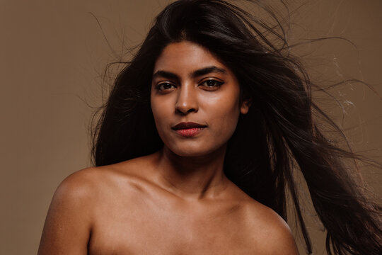 Professional beauty studio portrait on a young indian woman with long dark hair