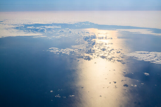 Aerial Sun Reflection On Ocean Through Clouds