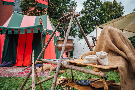 Medieval Festival Camp Scene With Colorful Tent Open Fire Pit And Wooden Table Setup Historical Reenactment Outdoor Living Exhibit