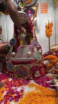 4k clip of Shivling or shiv lingam decorated with colours and flowers to worship lord shiv. Selective focus.
