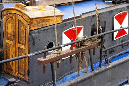 Historic Inland Waterway Barge with Wooden Cabin and Traditional Mooring Equipment