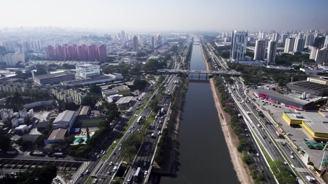 Drone going foward over the Tiet&ecirc; river and the Tiet&ecirc; roads aside and a viaduct