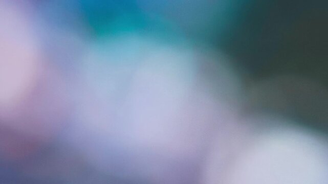 Abstract colorful background with glowing bokeh lights and dynamic moving shapes.