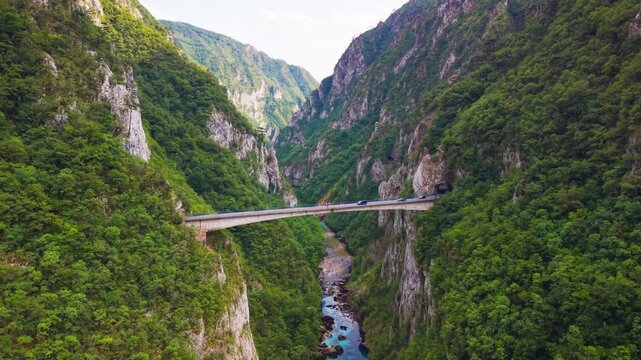 Scenic aerial view of a bridge spanning a deep canyon above the blue Piva River near the Montenegro border